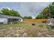 Large backyard with a wooden fence and a cozy patio area at 11104 Taft Dr, Port Richey, FL 34668