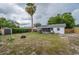 Large, fully fenced backyard with patio, shed, and mature trees at 11104 Taft Dr, Port Richey, FL 34668
