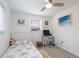 Bright bedroom with a single bed, desk setup, and natural light from the windows at 11104 Taft Dr, Port Richey, FL 34668