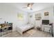 Bright bedroom with a single bed, desk setup, and natural light from the windows at 11104 Taft Dr, Port Richey, FL 34668