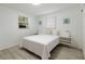Bright bedroom with a cozy queen-size bed, complemented by stylish decor and natural light from the windows at 11104 Taft Dr, Port Richey, FL 34668