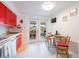 Cozy kitchen featuring red cabinetry and an adjacent dining area at 11104 Taft Dr, Port Richey, FL 34668