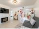 Bright living room with modern fireplace, tile floors, and access to dining area at 11104 Taft Dr, Port Richey, FL 34668