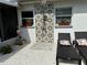 Private outdoor shower area with decorative tile, lounge chairs, and charming landscaping at 11104 Taft Dr, Port Richey, FL 34668