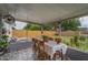 Enclosed patio with a dining table, offering a comfortable outdoor seating area and backyard view at 11104 Taft Dr, Port Richey, FL 34668