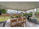 Covered patio with tiled floor, dining set, and grill, perfect for outdoor entertaining at 11104 Taft Dr, Port Richey, FL 34668