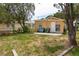 A spacious backyard with a cozy home featuring a small patio at 1142 7Th Nw St, Largo, FL 33770