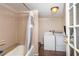 Bathroom and laundry room combined space with a shower and a washing machine and dryer at 1142 7Th Nw St, Largo, FL 33770