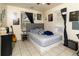 Comfortable bedroom featuring a queen-sized bed, stylish decor, and tile flooring for easy maintenance at 1142 7Th Nw St, Largo, FL 33770