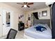 Bedroom featuring a queen-sized bed, tile flooring, and a mirrored closet door, maximizing space and light at 1142 7Th Nw St, Largo, FL 33770