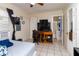 Bedroom view with tile flooring, featuring a study desk and an adjacent bathroom, ideal for focused work at 1142 7Th Nw St, Largo, FL 33770