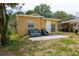 Cozy home with a small patio and outdoor seating at 1142 7Th Nw St, Largo, FL 33770