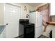 This kitchen features a white refrigerator, white door, and a black range stove at 1142 7Th Nw St, Largo, FL 33770