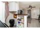 Kitchen area with appliances and shelving, leading into the living space at 1142 7Th Nw St, Largo, FL 33770