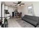 Open-concept living area featuring tile flooring, a ceiling fan, and a comfortable sofa, perfect for relaxing at 1142 7Th Nw St, Largo, FL 33770
