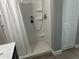 Shower stall with white shower curtain and shower head in a clean-looking bathroom at 11729 John Robbins Rd, Riverview, FL 33578