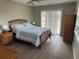 Bright bedroom featuring a queen-sized bed, ceiling fan, and sliding door access to the porch at 11729 John Robbins Rd, Riverview, FL 33578