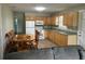 Cozy kitchen features wooden cabinets, white appliances, and an adjacent dining area for convenient meals at 11729 John Robbins Rd, Riverview, FL 33578