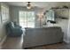Comfortable living room featuring a sliding glass door, ceiling fan and modern furnishings at 11729 John Robbins Rd, Riverview, FL 33578