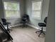 Office space featuring three office chairs and lots of natural light from two large windows at 11729 John Robbins Rd, Riverview, FL 33578