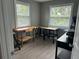 Office space with work tables, a drill press, and two windows for natural lighting at 11729 John Robbins Rd, Riverview, FL 33578