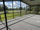 Enjoy outdoor living on this screened porch with expansive views of the surrounding landscape at 11729 John Robbins Rd, Riverview, FL 33578
