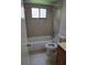 Cozy bathroom with a tub, toilet, and tiled walls for easy maintenance at 11802 Raintree Lake Ln # B, Temple Terrace, FL 33617