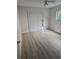 Bright bedroom with wood-look floors, window with shade, and access to outdoor space at 11802 Raintree Lake Ln # B, Temple Terrace, FL 33617