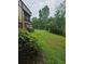 Exterior view of building and lawn with mature trees offering ample green space and natural beauty at 11802 Raintree Lake Ln # B, Temple Terrace, FL 33617