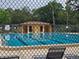Fenced community pool with a pool house, ensuring a private and safe recreational space at 11802 Raintree Lake Ln # B, Temple Terrace, FL 33617