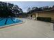 Community pool with lounge chairs, and a nearby pool house for residents to relax and socialize at 11802 Raintree Lake Ln # B, Temple Terrace, FL 33617