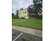 Exterior shot of a well-maintained apartment building with green lawn and sidewalks at 11802 Raintree Lake Ln # B, Temple Terrace, FL 33617