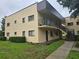 Exterior of the condo showcasing balconies, stairs, and well-manicured landscaping at 11802 Raintree Lake Ln # B, Temple Terrace, FL 33617