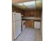 Functional kitchen with essential appliances, wood cabinets, and practical tile floors for easy maintenance at 11802 Raintree Lake Ln # B, Temple Terrace, FL 33617
