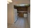 This kitchen features white appliances, wood cabinetry and tile flooring at 11802 Raintree Lake Ln # B, Temple Terrace, FL 33617