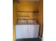 This practical laundry room comes equipped with shelving and laundry machines at 11802 Raintree Lake Ln # B, Temple Terrace, FL 33617