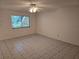 Bright living room featuring a window and tile floors throughout the space at 11802 Raintree Lake Ln # B, Temple Terrace, FL 33617
