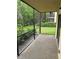 Enclosed patio with a view of the lawn and surrounding trees at 11802 Raintree Lake Ln # B, Temple Terrace, FL 33617