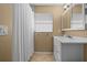 Cozy bathroom featuring a white vanity, a shower with white curtain and neutral colored tiling at 1226 Hermitage Ave, Clearwater, FL 33764