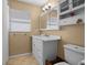 Well-lit bathroom featuring a pristine white vanity and neutral flooring with built in cabinet for extra storage at 1226 Hermitage Ave, Clearwater, FL 33764