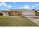 Charming single-story home with a well-manicured lawn and an attached two-car garage at 1226 Hermitage Ave, Clearwater, FL 33764