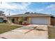 Charming single-story home with a well-manicured lawn, flower beds, and a two-car garage at 1226 Hermitage Ave, Clearwater, FL 33764
