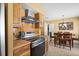 Modern kitchen with stainless steel appliances, wooden cabinets, and adjacent dining area at 1226 Hermitage Ave, Clearwater, FL 33764