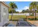 Outdoor patio with stylish seating and a fire pit, complemented by lush tropical landscaping at 1226 Hermitage Ave, Clearwater, FL 33764