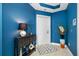 A bright blue entryway features a decorative console table, an accent rug, and a white entry door at 1325 Snell Isle Ne Blvd # 810, St Petersburg, FL 33704