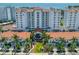 Aerial view of a luxury condominium building with a red tile roof, lush landscaping, and marina access at 1325 Snell Isle Ne Blvd # 810, St Petersburg, FL 33704