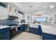 Modern kitchen featuring stainless steel appliances, blue cabinetry, and views of the water at 1325 Snell Isle Ne Blvd # 810, St Petersburg, FL 33704