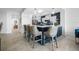 A modern kitchen featuring a navy blue island with bar seating and a decorative backsplash at 1325 Snell Isle Ne Blvd # 810, St Petersburg, FL 33704