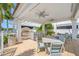 An elegant outdoor kitchen with bar seating, a grill, and a dining area perfect for al fresco meals at 1325 Snell Isle Ne Blvd # 810, St Petersburg, FL 33704