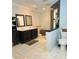 Spacious bathroom with double vanity, decorative tile flooring, and walk-in shower at 13601 Audrey Ln, Largo, FL 33771